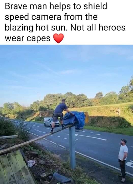 Brave man helps to shield speed camera from the blazing hot sun. Not all heroes wear capes
