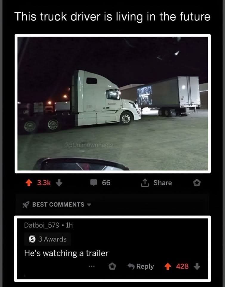 This truck driver is living in the future  
He's watching a trailer  